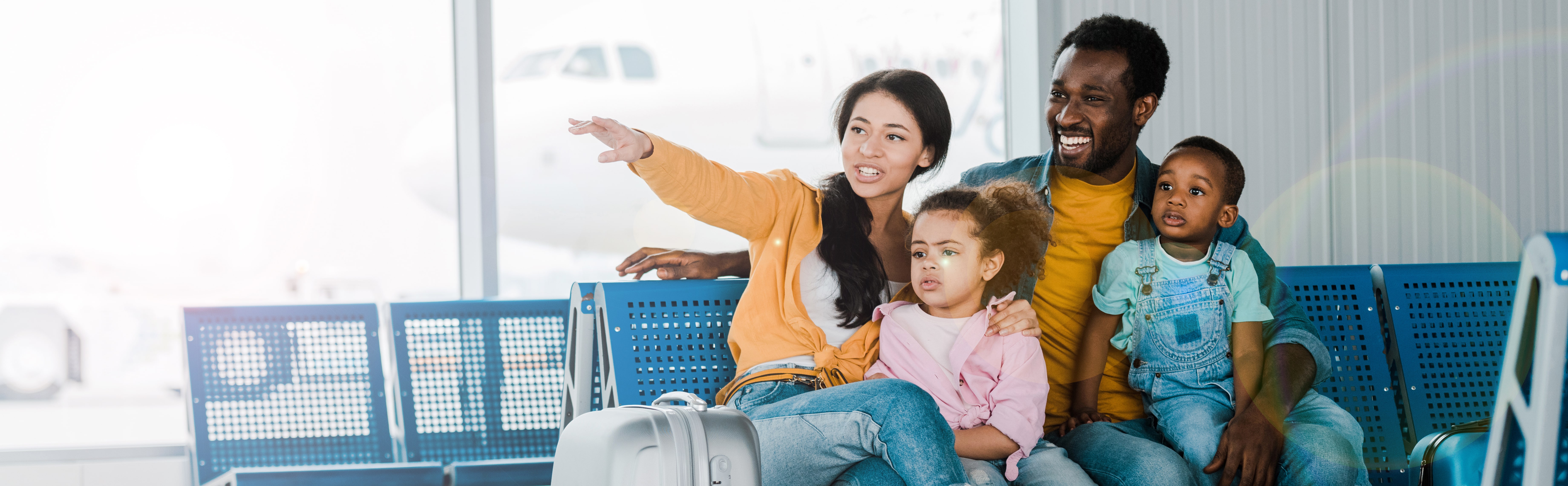 family of 4 wait at the airport for their flight